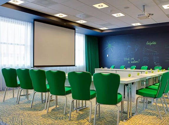 inside a radisson hotel meeting room with a large conference table and projector screen