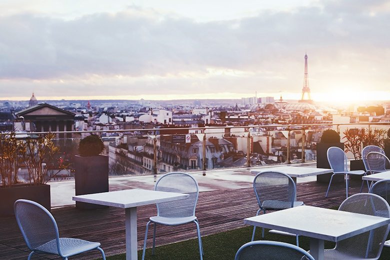 sunny terrace of restaurant in Paris with panoramic view on Eiffel tower, France